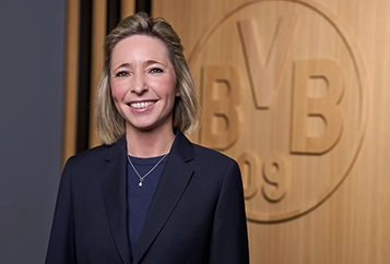 Svenja Schlenker – Managing Director – in a dark suit, looking directly into the camera (photo)