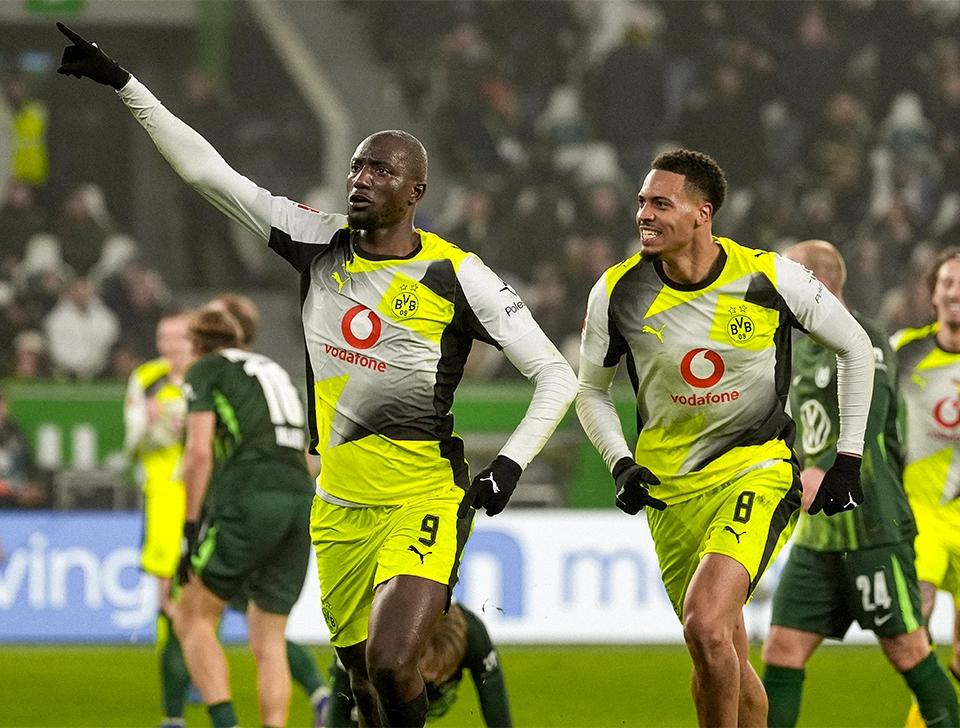 Guirassy and Nmecha celebrating a goal (photo)