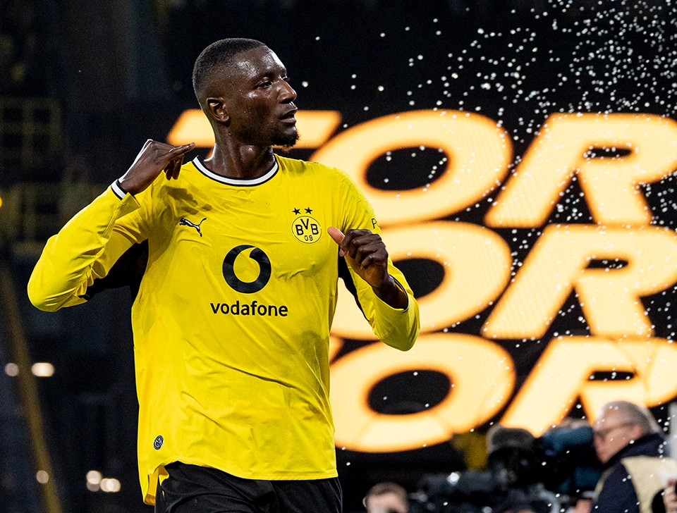 Guirassy celebrating, a video screen showing a goal in the background (photo)